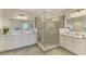 Bright bathroom features a glass shower enclosure, dual vanities, and ample lighting fixtures at 12590 Ghiberti Cir # 201, Venice, FL 34293