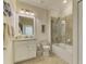 Bright bathroom featuring a glass-enclosed shower, vanity, and neutral tile flooring at 12590 Ghiberti Cir # 201, Venice, FL 34293