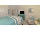 Relaxing bedroom featuring beach decor, a turquoise accent table, and a queen size bed at 12590 Ghiberti Cir # 201, Venice, FL 34293