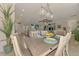 Bright dining room featuring a decorative chandelier, open floor plan, and an island with barstool seating at 12590 Ghiberti Cir # 201, Venice, FL 34293