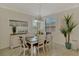 Charming dining room with a stylish table, plantation shutters and natural light at 12590 Ghiberti Cir # 201, Venice, FL 34293