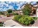 Charming townhome exterior with colorful landscaping, brick driveway, and attached garage at 12590 Ghiberti Cir # 201, Venice, FL 34293