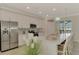 Spacious kitchen with stainless steel appliances, white cabinetry, and a large island with seating at 12590 Ghiberti Cir # 201, Venice, FL 34293