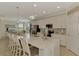 Bright, open kitchen features a large island, stainless steel appliances, and white cabinetry at 12590 Ghiberti Cir # 201, Venice, FL 34293