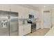 Kitchen features stainless steel appliances and white cabinetry, complemented by a marble backsplash at 12590 Ghiberti Cir # 201, Venice, FL 34293