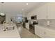 Bright kitchen showcasing stainless steel appliances, sleek white cabinets, and a modern design at 12590 Ghiberti Cir # 201, Venice, FL 34293