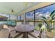 Screened lanai overlooking a tranquil pond, furnished with a dining table and chairs at 12590 Ghiberti Cir # 201, Venice, FL 34293