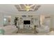 Cozy living room featuring white furnishings, a custom ceiling, and coastal-themed accents at 12590 Ghiberti Cir # 201, Venice, FL 34293