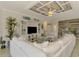 Bright, spacious living room with custom ceilings and an open layout into the kitchen and dining at 12590 Ghiberti Cir # 201, Venice, FL 34293