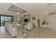 Bright living room with white sofas, large windows, and stylish coastal-themed decor at 12590 Ghiberti Cir # 201, Venice, FL 34293