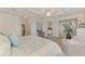 Comfortable main bedroom boasts a tray ceiling, seating area, and ensuite bathroom access at 12590 Ghiberti Cir # 201, Venice, FL 34293