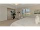 Relaxing main bedroom features a tray ceiling, plantation shutters, and a quaint seating area at 12590 Ghiberti Cir # 201, Venice, FL 34293