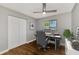 Cozy home office featuring wood floors, a modern ceiling fan and ample natural light at 12590 Ghiberti Cir # 201, Venice, FL 34293