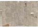 Neutral shower with stone-look tiles, a hand shower, and built-in soap dish at 12590 Ghiberti Cir # 201, Venice, FL 34293