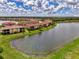 A picturesque water view of condo residences surrounded by lush greenery and a serene lake at 12590 Ghiberti Cir # 201, Venice, FL 34293