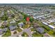 An aerial shot highlighting a home nestled in a community with tree-lined streets and water access at 1315 Pine Needle Rd, Venice, FL 34285