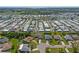 An aerial view of a community showcasing numerous homes, lush landscaping, and various neighborhood amenities at 1315 Pine Needle Rd, Venice, FL 34285