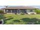 A spacious backyard with green grass and tropical landscaping, perfect for outdoor enjoyment at 1315 Pine Needle Rd, Venice, FL 34285