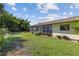 Beautiful backyard with a screened porch, manicured lawn, and vibrant landscaping, great for relaxation and entertaining at 1315 Pine Needle Rd, Venice, FL 34285