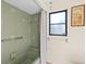 Bathroom featuring tiled walls, a bathtub with shower, and a window at 1315 Pine Needle Rd, Venice, FL 34285