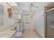 Bright bathroom with ample counter space, storage cabinets, and a glass enclosed shower at 1315 Pine Needle Rd, Venice, FL 34285
