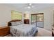 Comfortable bedroom featuring neutral walls, carpet floors, ceiling fan, and an sliding glass door to sunroom at 1315 Pine Needle Rd, Venice, FL 34285