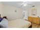 Cozy bedroom featuring neutral walls, light wood floors, ceiling fan, and a double door leading to another room at 1315 Pine Needle Rd, Venice, FL 34285