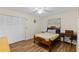 Bedroom featuring neutral walls, light wood floors, and a built-in closet for ample storage space at 1315 Pine Needle Rd, Venice, FL 34285