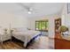 Bedroom featuring a ceiling fan, access to the porch, and hardwood floors at 1315 Pine Needle Rd, Venice, FL 34285