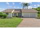 Charming single-story home with a well-maintained lawn, two-car garage, and inviting entrance at 1315 Pine Needle Rd, Venice, FL 34285
