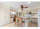 Functional kitchen with an island, a ceiling fan, white appliances, and ample storage space at 1315 Pine Needle Rd, Venice, FL 34285
