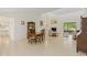 Bright living room with tile floors, fireplace, dining area, and sliding doors to the outdoors at 1315 Pine Needle Rd, Venice, FL 34285