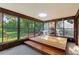 Bright sunroom with large windows offering scenic views of the beautifully landscaped backyard at 1315 Pine Needle Rd, Venice, FL 34285