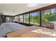 Bright sunroom featuring large windows offering scenic views of the beautifully landscaped backyard at 1315 Pine Needle Rd, Venice, FL 34285