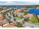 Aerial view of a lakeside community with homes featuring tile roofs and well-maintained landscaping at 13334 Pacchio St, Venice, FL 34293
