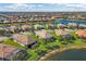 Expansive aerial view of a residential community surrounding a lake at 13334 Pacchio St, Venice, FL 34293