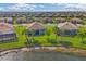 Aerial view of homes with tile roofs and palm trees overlooking the lake at 13334 Pacchio St, Venice, FL 34293
