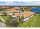 Scenic aerial view of a residential community with tile-roofed houses near a picturesque lake at 13334 Pacchio St, Venice, FL 34293