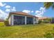 Spacious green backyard featuring covered patio, well-maintained lawn, and beautiful landscaping at 13334 Pacchio St, Venice, FL 34293