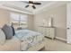 Bright bedroom showcasing a comfortable bed, stylish dresser, and a sunlit window for a relaxing and inviting space at 13334 Pacchio St, Venice, FL 34293