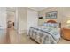 Cozy bedroom showcasing a spacious closet, tropical-themed decor, and a view into a bright, adjoining room at 13334 Pacchio St, Venice, FL 34293
