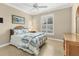 Comfortable bedroom featuring a ceiling fan, plantation shutters, and tropical artwork for a relaxing atmosphere at 13334 Pacchio St, Venice, FL 34293