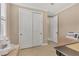 Neutral bedroom featuring a closet with white sliding panel doors, beige flooring and walls, and natural light at 13334 Pacchio St, Venice, FL 34293