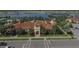Front view of the community clubhouse showcasing well-manicured landscaping and inviting architecture at 13334 Pacchio St, Venice, FL 34293