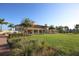 Exterior view of the clubhouse with green lawn and manicured landscaping at 13334 Pacchio St, Venice, FL 34293