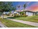 Well-maintained single-story home with lush landscaping, tile roof, and a neatly paved walkway at 13334 Pacchio St, Venice, FL 34293