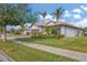 Single-story home featuring lush landscaping, a tile roof, and a well-manicured lawn at 13334 Pacchio St, Venice, FL 34293