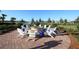Outdoor fire pit area with Adirondack chairs and lake view at 13334 Pacchio St, Venice, FL 34293
