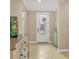 Inviting foyer featuring a decorative glass front door, neutral walls, and tiled flooring at 13334 Pacchio St, Venice, FL 34293