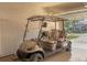 Garage featuring golf cart with comfortable seating, concrete block wall, and roll up door at 13334 Pacchio St, Venice, FL 34293